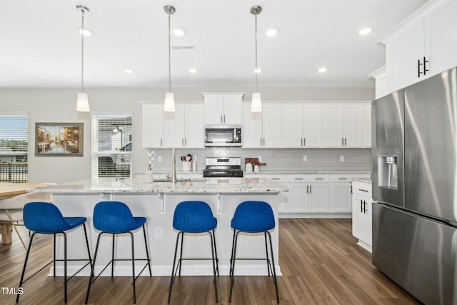 5009 Megara Run, Raleigh, NC 27603 - kitchen with appliances with stainless steel finishes, plenty of natural light, decorative backsplash, dark wood-style floors, and recessed lighting