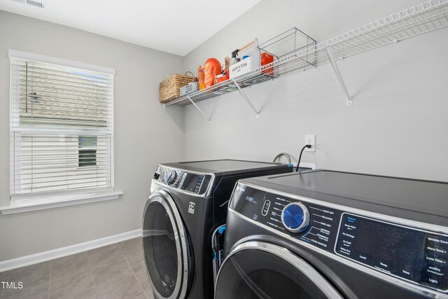 5009 Megara Run, Raleigh, NC 27603 - laundry area with washing machine and clothes dryer, baseboards, and tile patterned floors