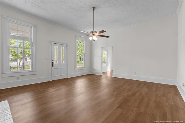 unfurnished living room with a textured ceiling, baseboards, a ceiling fan, and wood finished floors