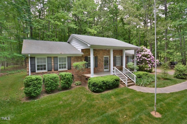 view of front of house with brick siding and a front yard