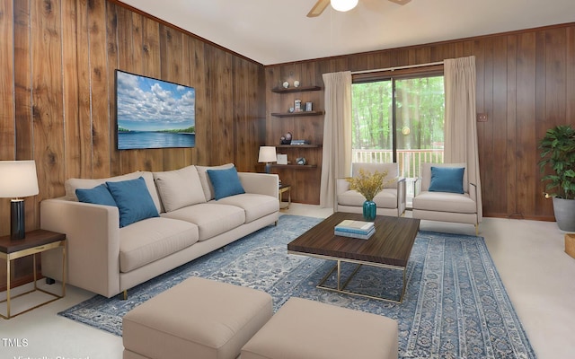 living room featuring ceiling fan and wooden walls
