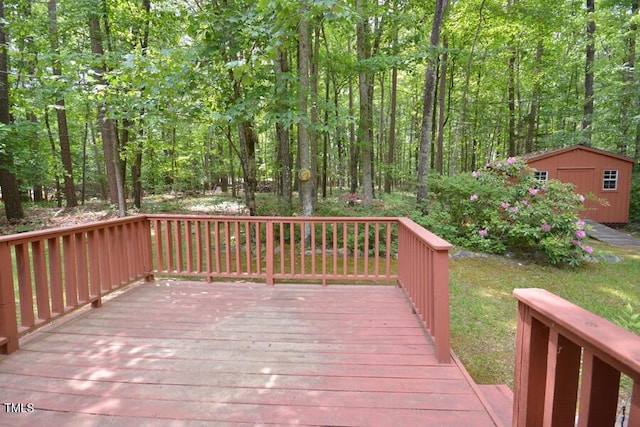 deck featuring an outdoor structure and a storage unit