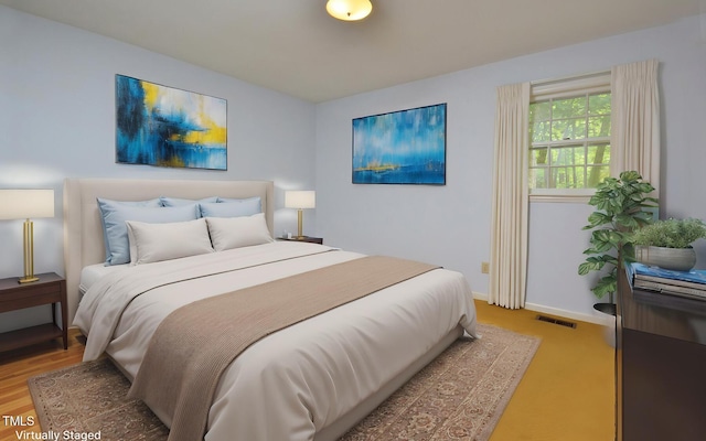 bedroom featuring visible vents and baseboards