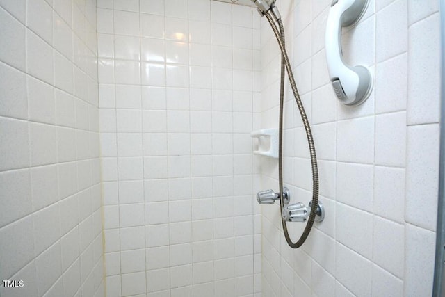 full bath with a tile shower