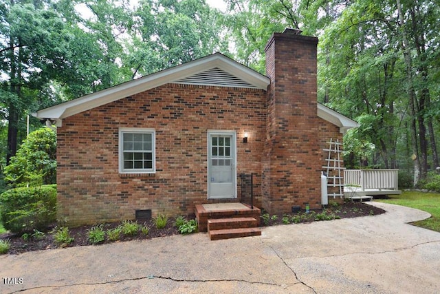5825 Scalybark Rd, Durham, NC 27712 - view of front of property with a chimney, brick siding, crawl space, and a wooden deck