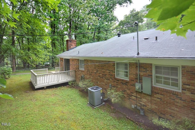 5825 Scalybark Rd, Durham, NC 27712 - view of side of property with a wooden deck, a lawn, a chimney, crawl space, and brick siding