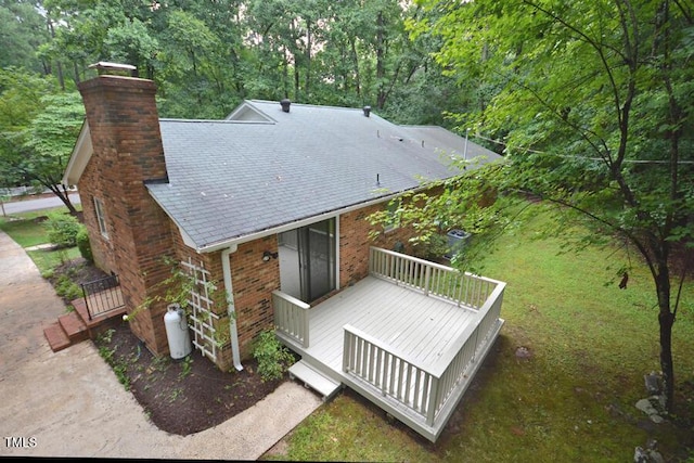 5825 Scalybark Rd, Durham, NC 27712 - back of house featuring a chimney, a wooden deck, brick siding, and a forest view