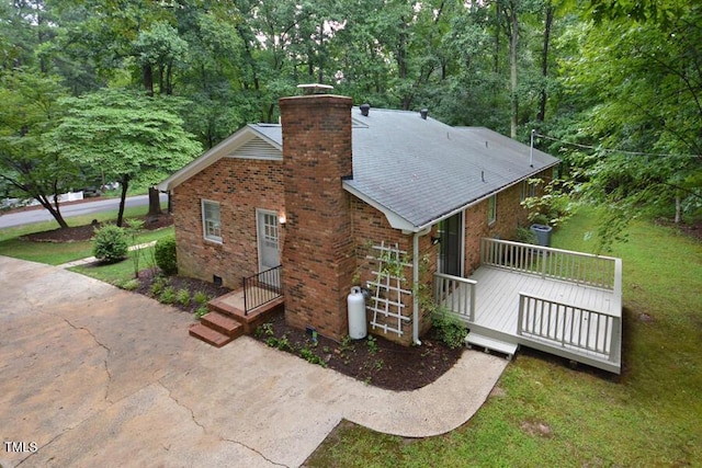 5825 Scalybark Rd, Durham, NC 27712 - view of side of property with brick siding, a chimney, a lawn, and concrete driveway