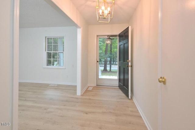 5825 Scalybark Rd, Durham, NC 27712 - entrance foyer featuring plenty of natural light, light wood finished floors, and a chandelier