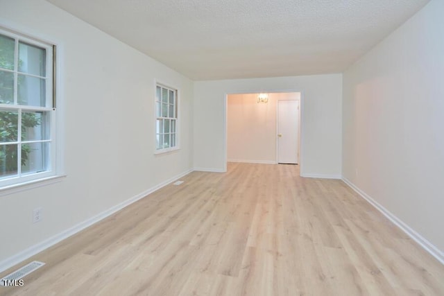 5825 Scalybark Rd, Durham, NC 27712 - unfurnished room with wood finished floors and a textured ceiling