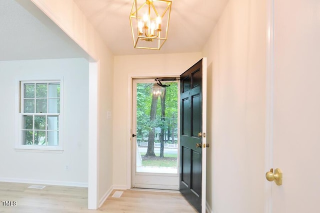 5825 Scalybark Rd, Durham, NC 27712 - foyer with light wood finished floors and a chandelier