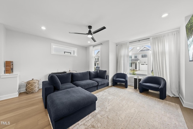 living room with baseboards, recessed lighting, a ceiling fan, and wood finished floors