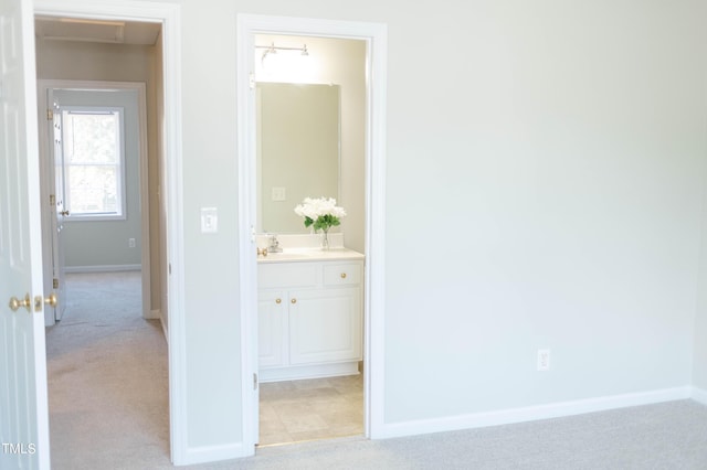 278 S Raleigh St, Angier, NC 27501 - corridor with a sink, baseboards, and light colored carpet
