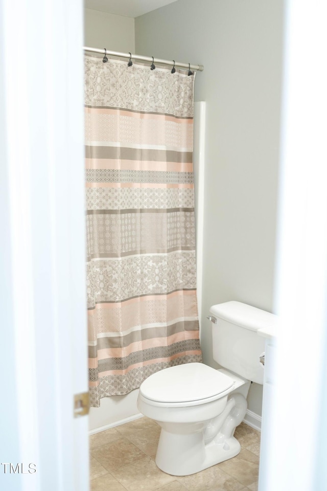 278 S Raleigh St, Angier, NC 27501 - bathroom featuring tile patterned floors, toilet, and a shower with shower curtain