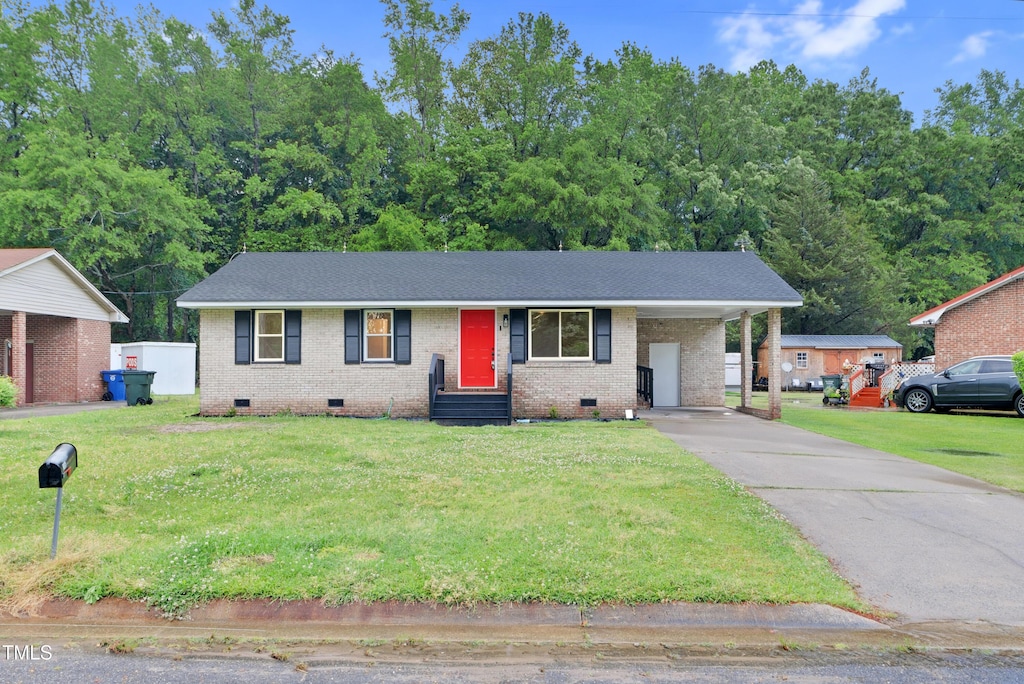 2116 Cedar Ln, Kinston, NC 28501 - single story home with a front lawn, brick siding, an attached carport, crawl space, and driveway