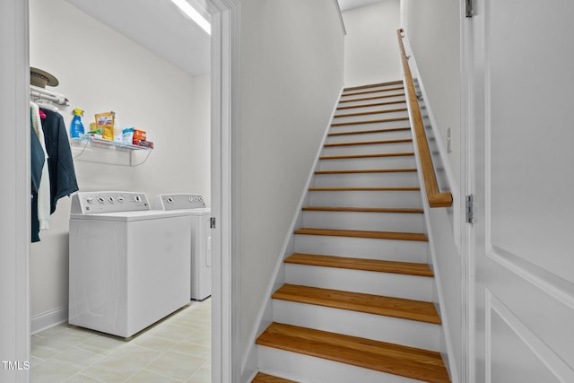 staircase featuring separate washer and dryer and baseboards