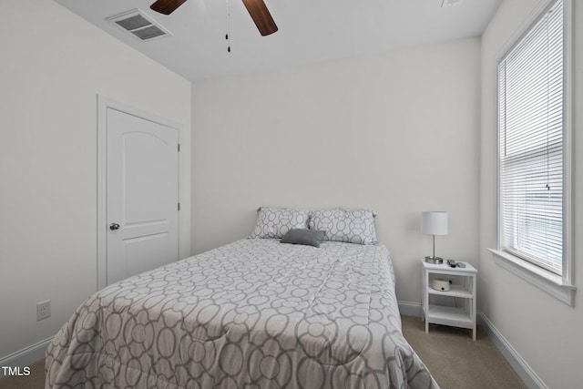 bedroom with baseboards, multiple windows, carpet flooring, and visible vents