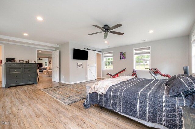 553 Isley Rd, Haw River, NC 27258 - bedroom with a barn door, wood finished floors, recessed lighting, baseboards, and ceiling fan