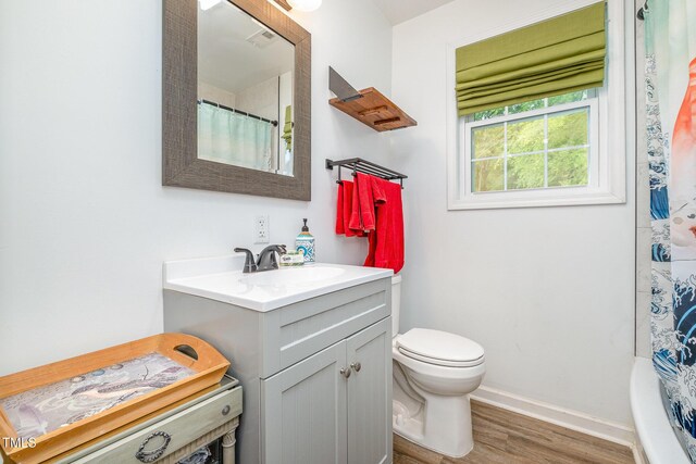 553 Isley Rd, Haw River, NC 27258 - full bath with wood finished floors, vanity, toilet, and baseboards