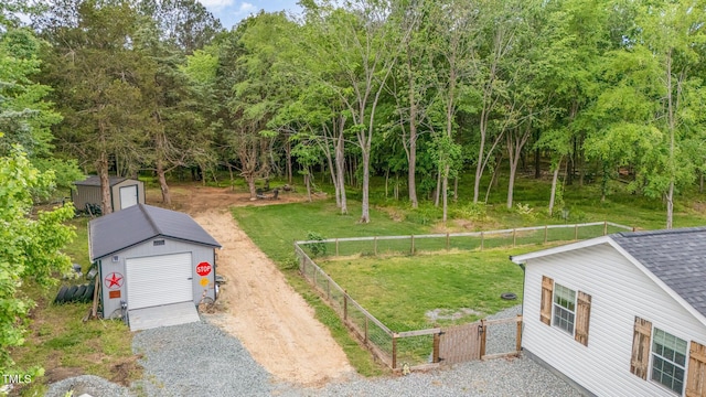 553 Isley Rd, Haw River, NC 27258 - view of yard featuring a storage unit, an outbuilding, gravel driveway, and a detached garage
