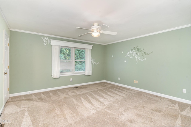 carpeted spare room featuring baseboards, ceiling fan, and ornamental molding