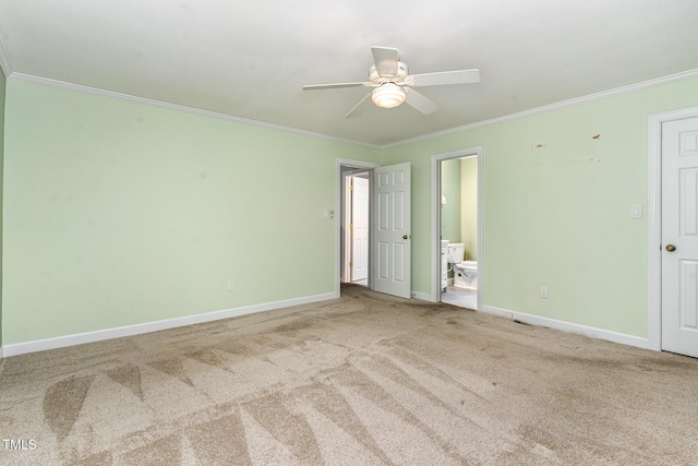 unfurnished bedroom featuring crown molding, baseboards, carpet, and connected bathroom