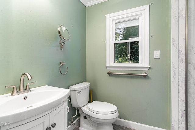 bathroom with vanity, baseboards, and toilet