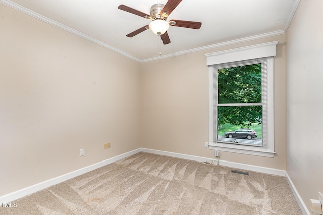 spare room with carpet flooring, crown molding, visible vents, and baseboards