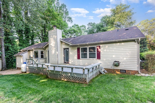 rear view of house with a yard, crawl space, a chimney, and a shingled roof