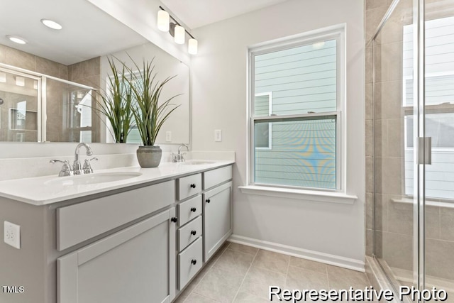 207 Curling Creek Dr Unit 300P, Clayton, NC 27527 - bathroom featuring double vanity, baseboards, a sink, and a stall shower