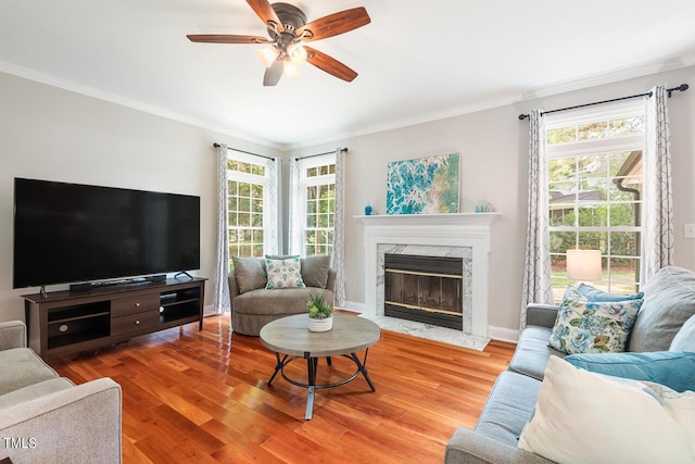 116 Dallavia Ct, Morrisville, NC 27560 - living room featuring ceiling fan, light wood-style flooring, a healthy amount of sunlight, a high end fireplace, and ornamental molding