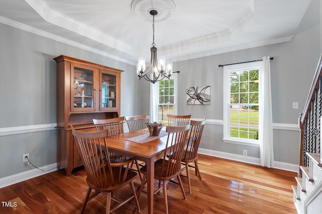 116 Dallavia Ct, Morrisville, NC 27560 - dining room with a raised ceiling, a chandelier, hardwood / wood-style floors, stairs, and baseboards
