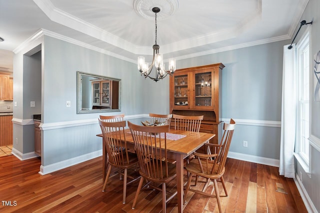 116 Dallavia Ct, Morrisville, NC 27560 - dining space with visible vents, ornamental molding, hardwood / wood-style floors, a raised ceiling, and a chandelier