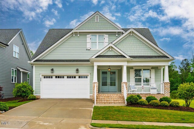 328 Boone St, Chapel Hill, NC 27516 - craftsman house with a porch, concrete driveway, a front lawn, and a shingled roof