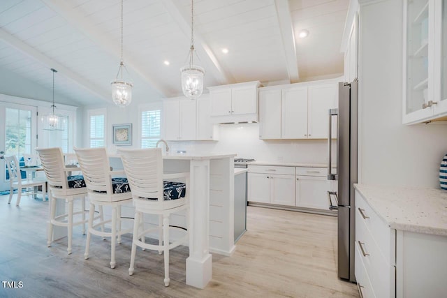 328 Boone St, Chapel Hill, NC 27516 - kitchen featuring white cabinets, a chandelier, light wood finished floors, a kitchen breakfast bar, and recessed lighting