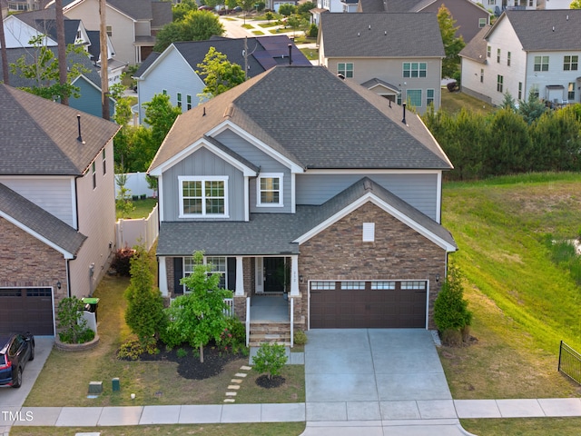 view of front of home with board and batten siding, roof with shingles, a residential view, and concrete driveway