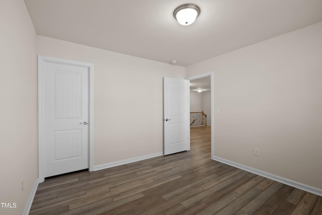 unfurnished bedroom with baseboards and wood finished floors