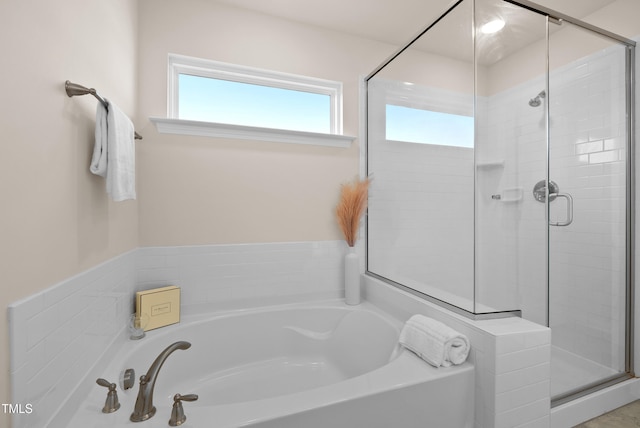 full bath with a bath and a shower stall