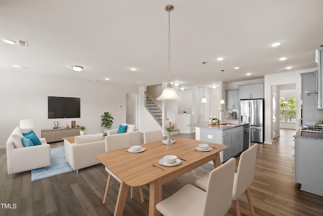 dining space featuring visible vents, recessed lighting, stairs, and dark wood-style flooring