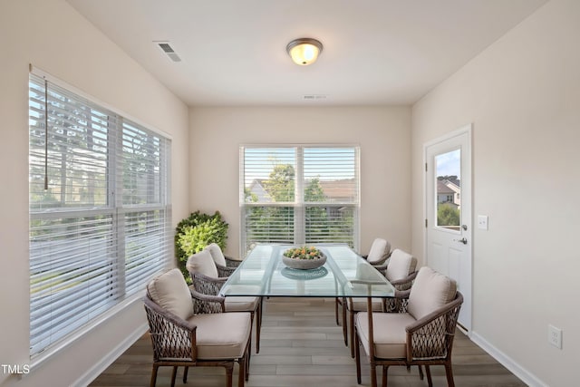 dining space with visible vents, wood finished floors, and a wealth of natural light