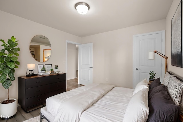 bedroom with baseboards and light wood finished floors