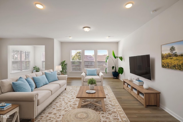 living area with baseboards, recessed lighting, and wood finished floors