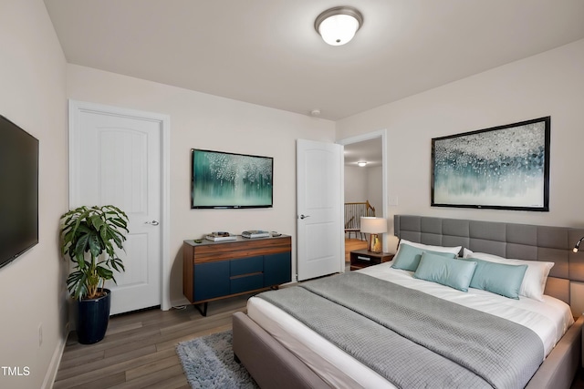 bedroom with baseboards and wood finished floors