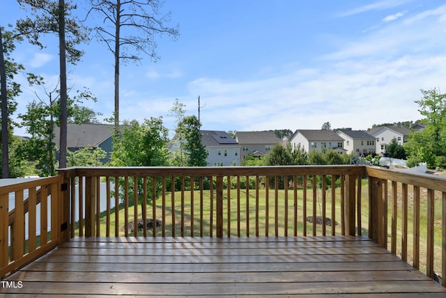 wooden deck with a lawn and a residential view
