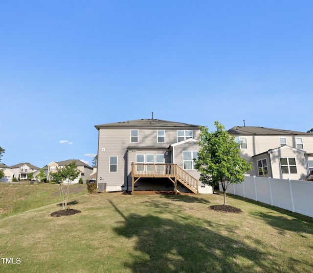 rear view of property with a wooden deck, fence, stairs, a yard, and a residential view