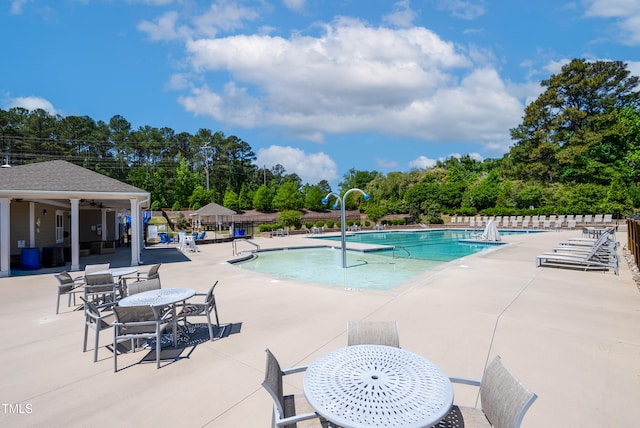 pool with fence and a patio area
