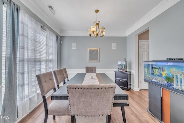 312 Grassy Point Rd, Apex, NC 27502 - dining room featuring a chandelier, light wood finished floors, and ornamental molding