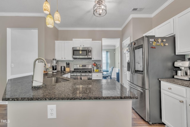 312 Grassy Point Rd, Apex, NC 27502 - kitchen with appliances with stainless steel finishes, a sink, crown molding, white cabinets, and dark stone counters