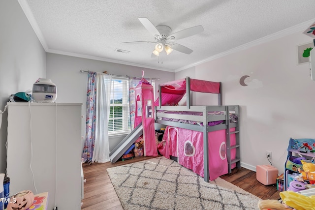 312 Grassy Point Rd, Apex, NC 27502 - bedroom with wood finished floors, a textured ceiling, crown molding, ceiling fan, and baseboards