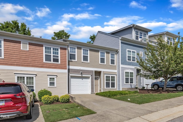 townhome / multi-family property featuring a garage and concrete driveway